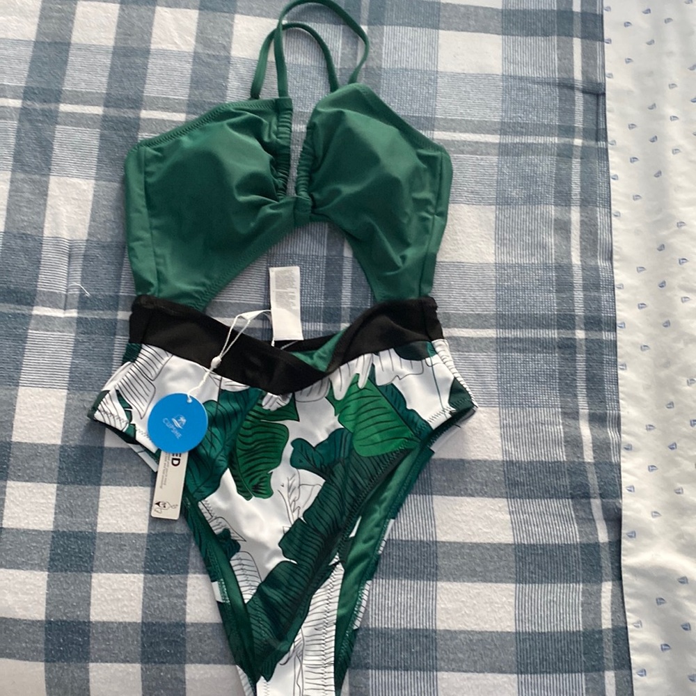 One piece , brand new tags still on , green , black and white